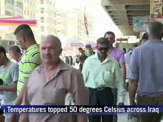 Streetside showers in boiling Baghdad summer