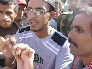 Yemeni protester holds up 'shell fired by government forces'