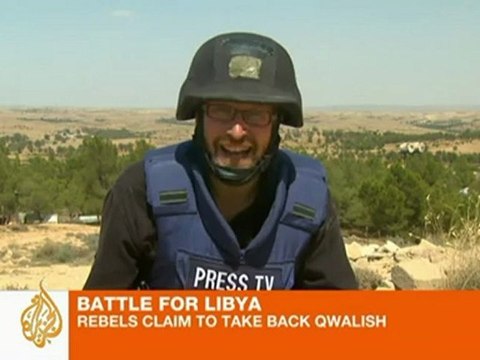 Libyan forces and rebels fight over mountain town