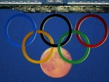 Beautiful pictures as the Moon rises behind Olympic rings