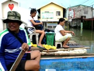 In flooded Philippines, living and dead share shelter