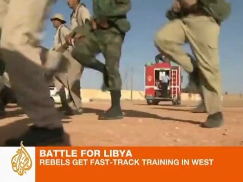 Libyan rebel fighters train on the job