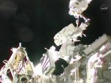 Spacewalking astronauts repair station's power system