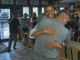 Obama bear hugged by huge pizza shop owner