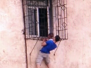 Superhero Rescue for Child Dangling From Window