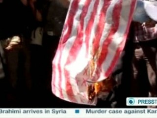 Iranians burn U.S. flag, protest film
