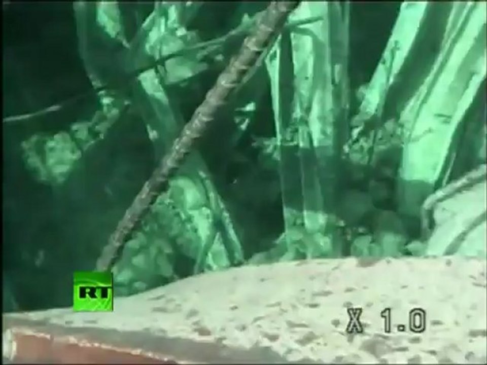 Close-up underwater footage of Fukushima reactor spent fuel pool in debris