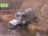 Off-roaders crossing heap-deep river