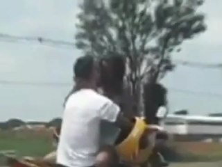 Couple kiss as they ride motorbike at 50mph.