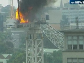 Burning construction crane collapses