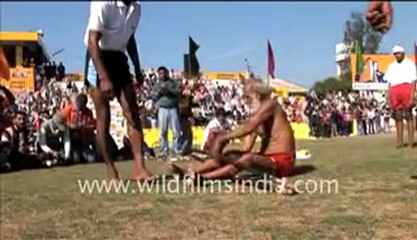 Man squeezing body through iron rods!