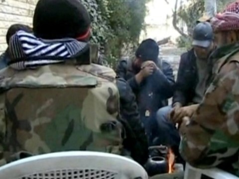 Rebels take aim at military base in battle to control Syria