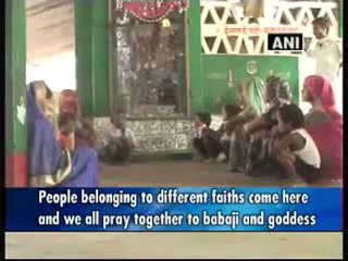 Devotees visit mazar and temple located adjacent.mp4