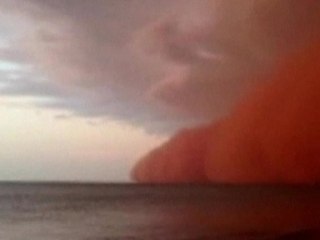 Wall of sand sweeps Australian beach