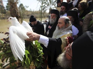 Worshippers Re-enact Baptism Of Jesus Christ In The Jordan River
