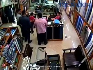 Two police allegedly tried to extort money for the Chinese New Year from a suit-shop owner.