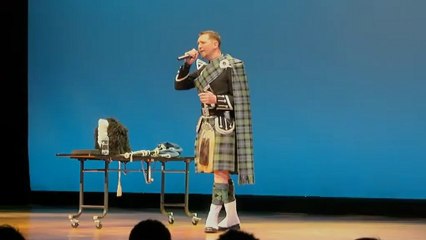 Mr. Adamson plays bugpipes and sings a song at farewell party