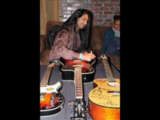 Anand Bhatt Signs Guitars for Autism Speaks