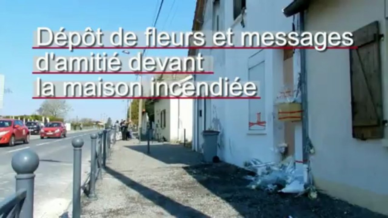 Roses blanches devant la maison incendiée à Saint-Quentin