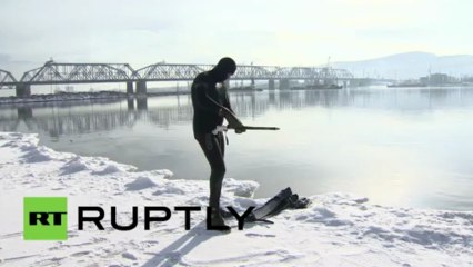 Russia- Siberian fisherman takes the hunt under the waves