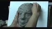 Sculpting a female face in clay