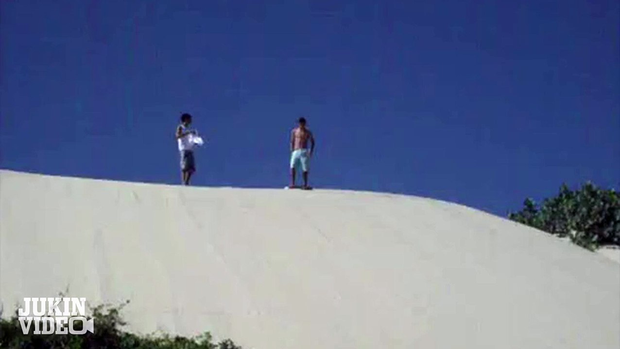 Shirtless Sandboarder Takes a Spill
