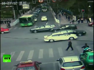 CCTV: Chinese driver zooms off with cop on hood