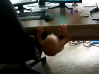 Baby trying to pull his self to watch cartoon