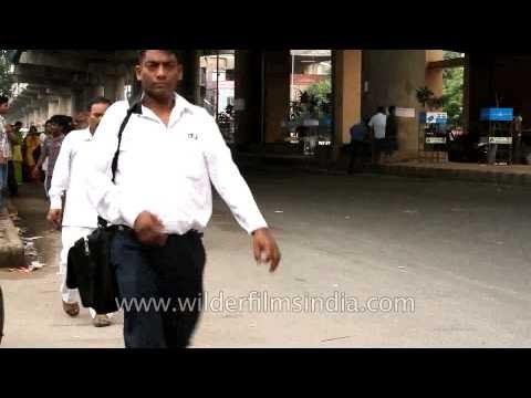 Commuters passing by Shadipur metro station, Delhi