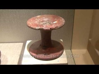 Historical pottery of red ware on display at an exhibition: Rediscovering India 1961-2011