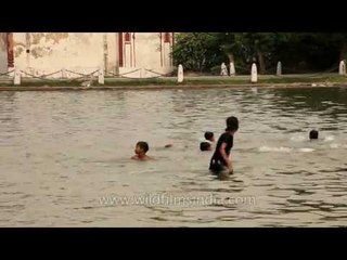 Boys take a dip to beat the extreme summer heat in Delhi