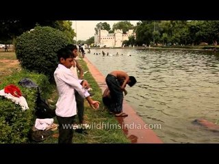 Kids dressing up after splashing around in the waterways near India Gate