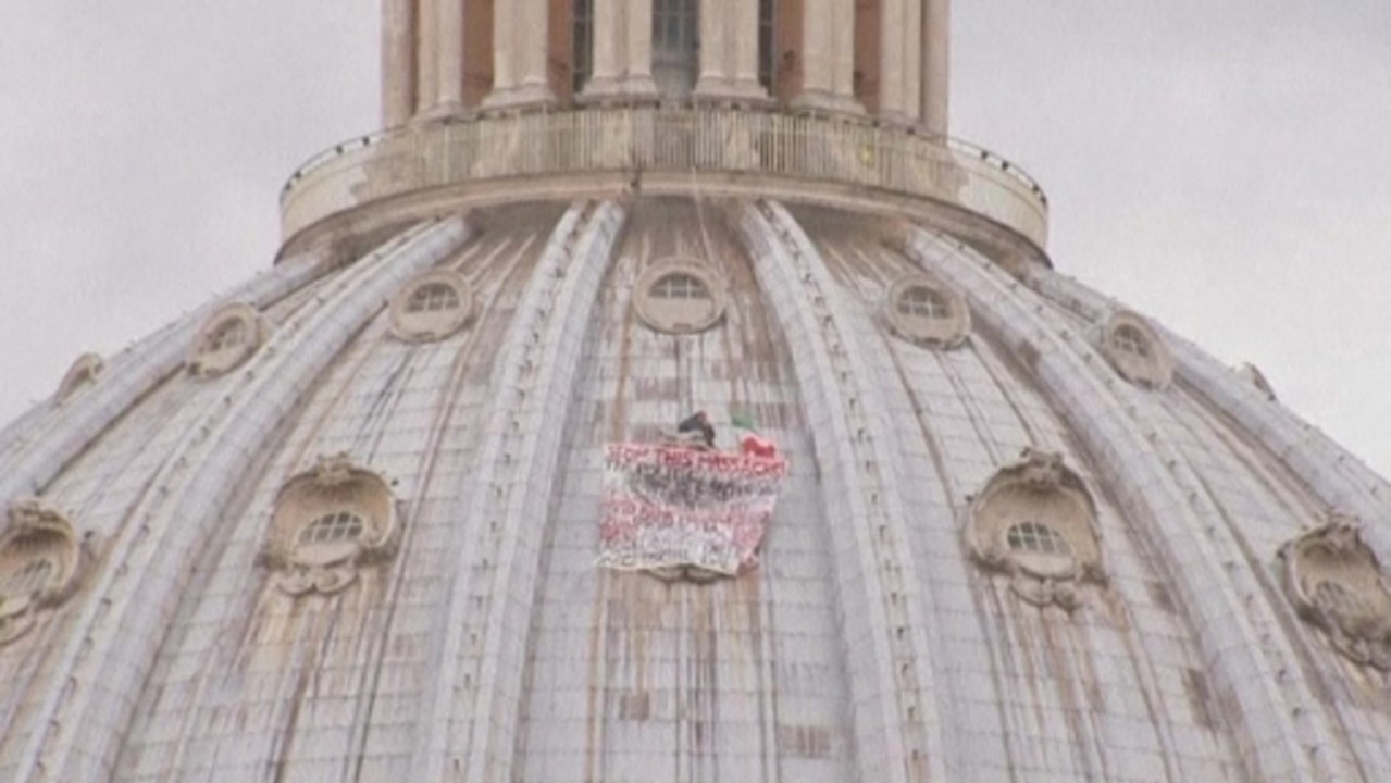 Man scales holy St Peter's for protest