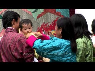 Bhutanese couple with their child at Kurjey Temple of Bhutan