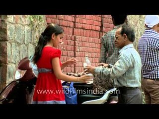 Girl shares water with father at Gargi College gate
