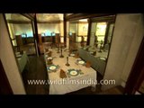 Crockery displayed with the dining table and chairs designed by Sir Edwin Lutyens