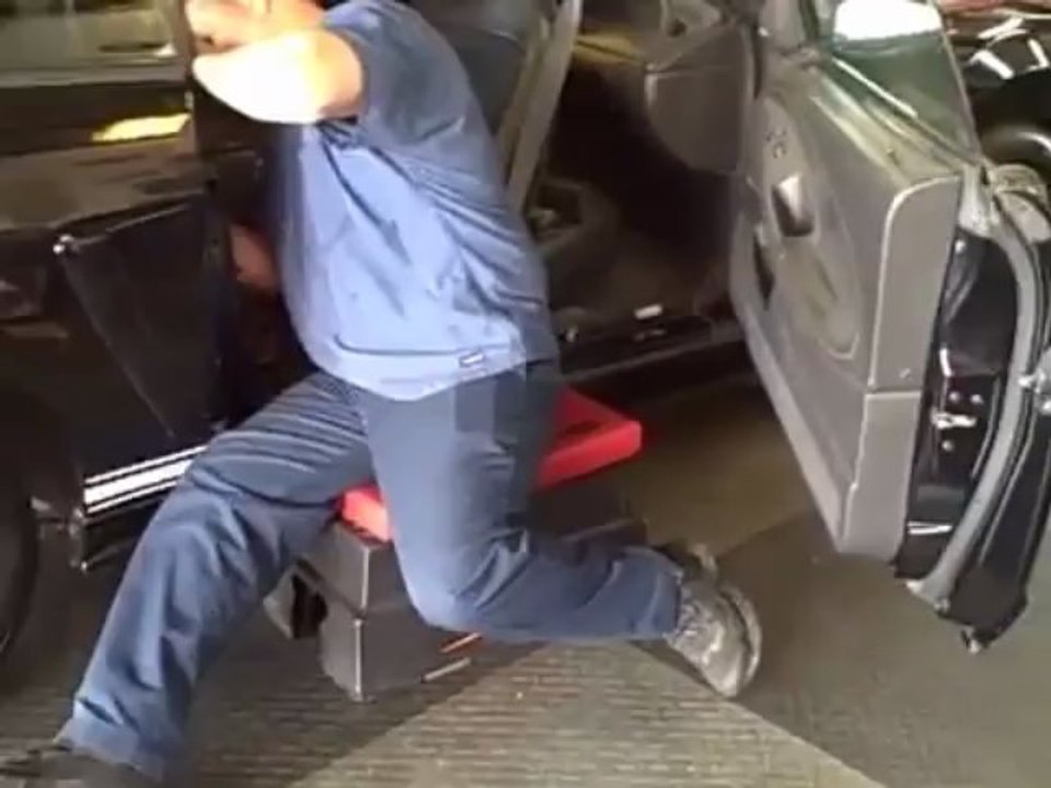 How a Mechanic Uses a Step Stool to Work on Automotive Interiors