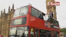 Magician levitates on side of  bus