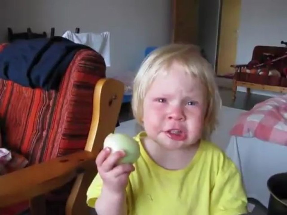 This girl eats a whole onion.