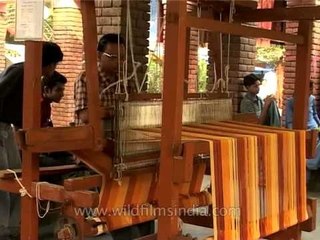 Weaver working a traditional loom - Indian handicrafts