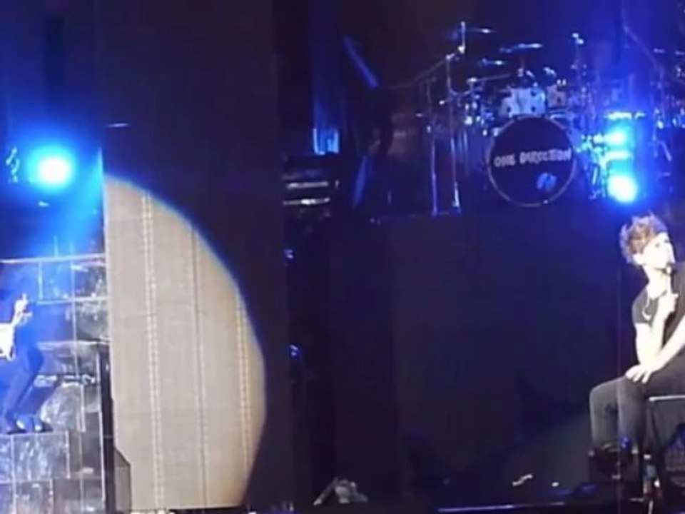 One Direction's Zayn Malik nibbles at Harry Styles' candy thong on stage