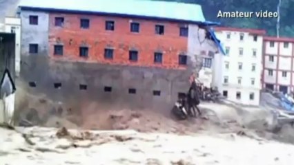 Buildings collapse in China floods