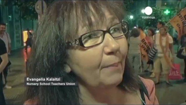 Greeks hold a protest concert on the eve of a third...