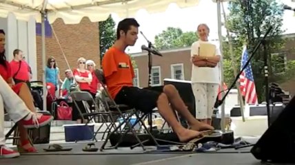 Armless man playing guitar