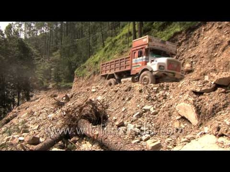Cars and Trucks ply on dangerous roads: Post Flood scenes at Agastyamuni