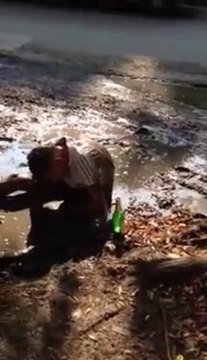A russian drunk guy dives into a puddle of mud.. So ridiculous!
