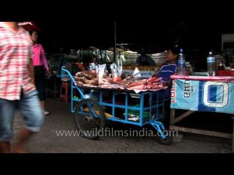 Woman selling dried insects on the streets of Bangkok