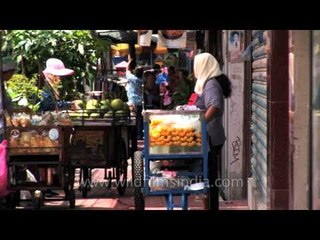 Fruits and fast food stalls on a Bangkok Street