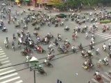 Crazy traffic at road Intersection in Vietnam - Thousands of Motorbikes & Scooters