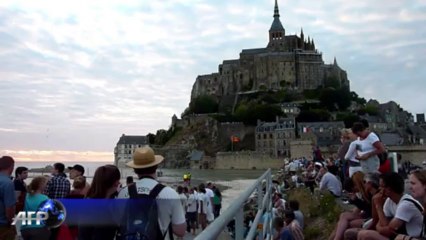 Tide surrounds 1000-year-old church as hundreds watch